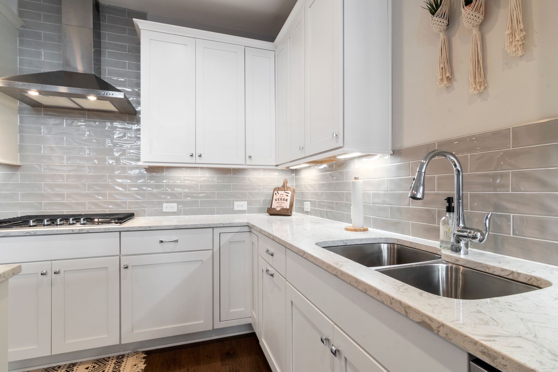 Sleek white kitchen with marble countertops and modern fixtures in Austin, TX